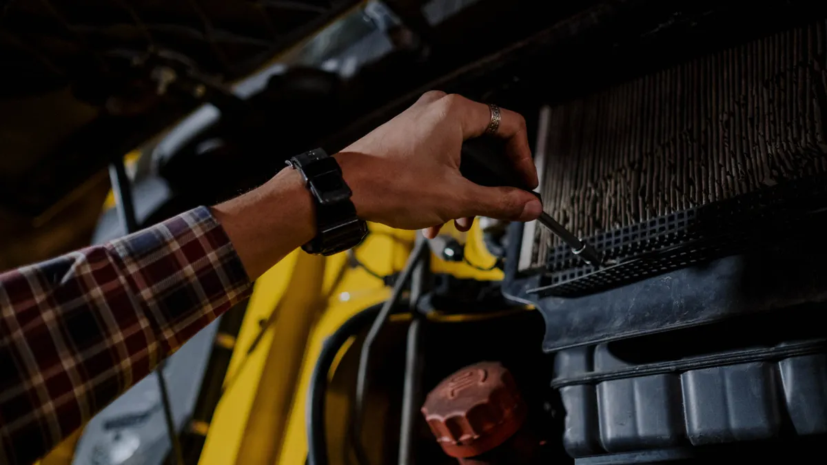 Person checking a dirty filter in equipment housing
