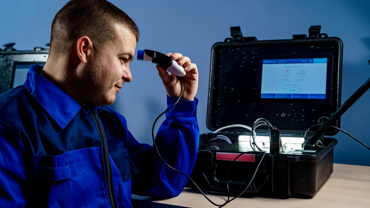 Technician using diagnostic equipment on HVAC system